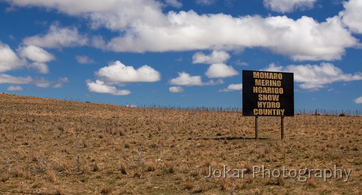 Brookfield Park.jpg - Monaro Merino Country.  The base photograph for this image was taken on The Arable Road, just at its junction with the Cooma-Jindabyne Road near the Cooma Airport. The ‘real’ sign marks the boundary of the ‘Brookfield Park’ property.Like the Cooma Welcomes You image, it was inspired by another sign, whose message is “Monaro Merino Country”. A few additions to that message (there could have been more) allow for some alternative designations of the land.
